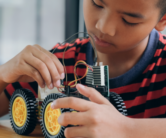 Desktop young boy building car